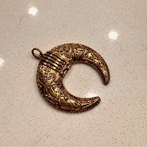Moon necklace pendant measures 1 1/4” wide. Gorgeous gold color.